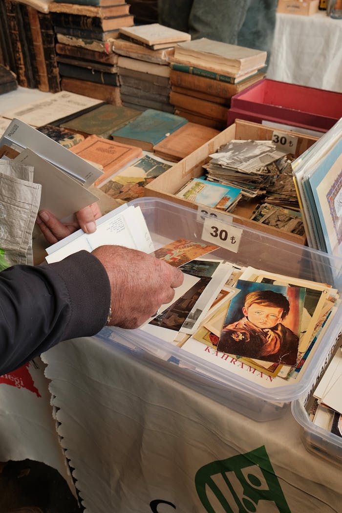 gallery-1 Person browsing vintage photographs at an outdoor market in Ankara, Türkiye.