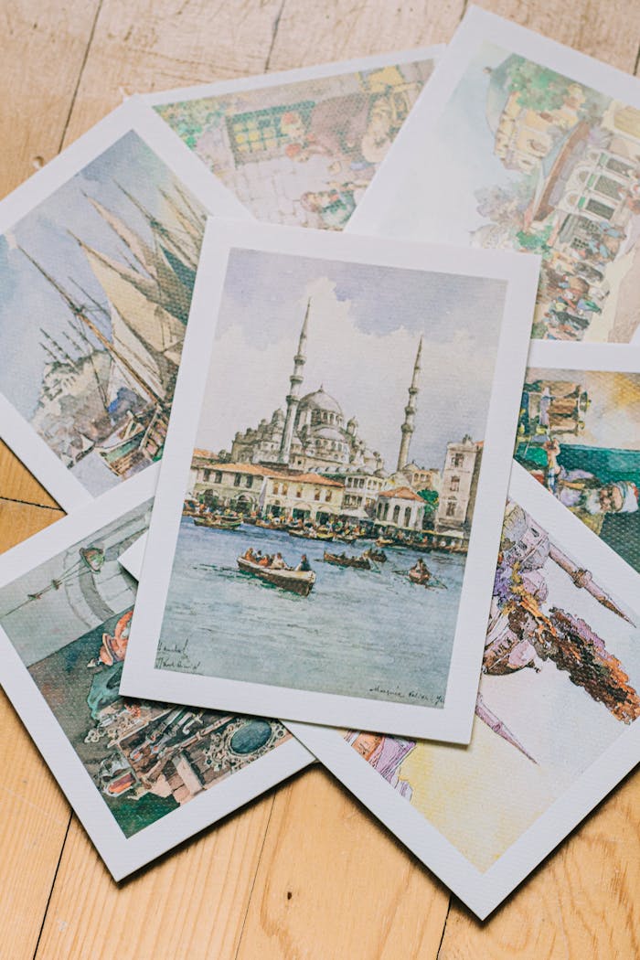 gallery-3 A collection of beautifully illustrated vintage art postcards displayed on a wooden surface.
